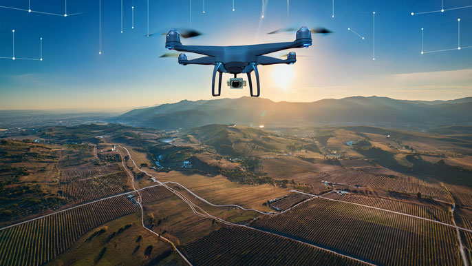 A drone flying over a vast agricultural landscape with glowing satellite signals from the sky, symbolizing GNSS-powered navigation and real-time accuracy for autonomous drone operations.