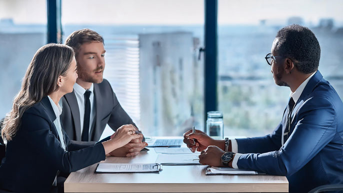 A diverse Internal Committee in a formal meeting setting discusses workplace policies, symbolizing commitment to POSH compliance and creating a respectful work environment.