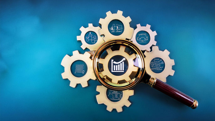 A magnifying glass on interconnected gears with icons for productivity, engagement, satisfaction, and financial impact, symbolizing analysis of transformation success metrics.