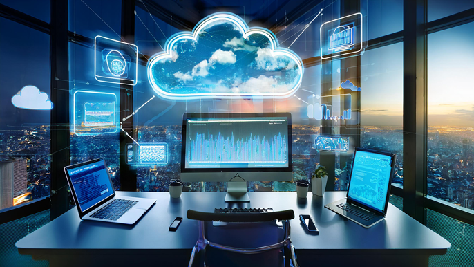 Modern office setup featuring multiple devices connected to a digital cloud, symbolizing cloud computing for business efficiency and data management.