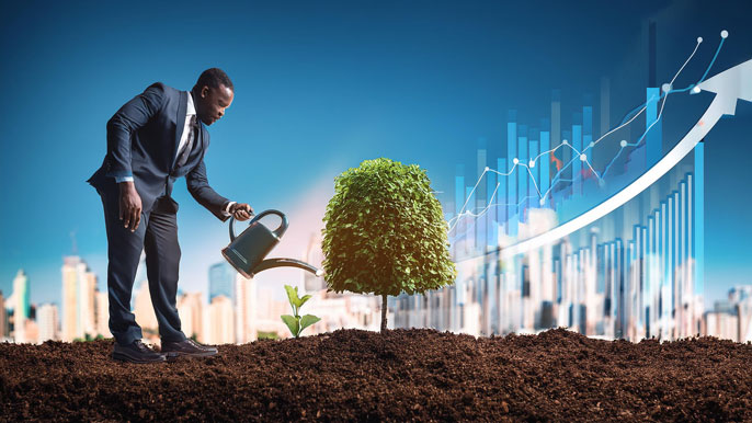 A businessman in a suit watering a small tree in soil, with financial graphs and an upward arrow in the background symbolizing business growth through effort.