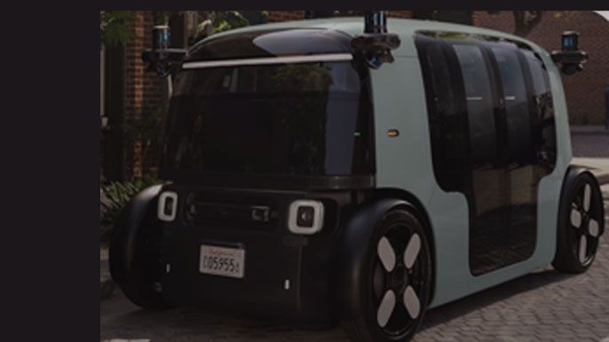 Close-up of Zoox&#039;s fully autonomous electric robotaxi parked outdoors, showcasing its innovative design and sensor technology.